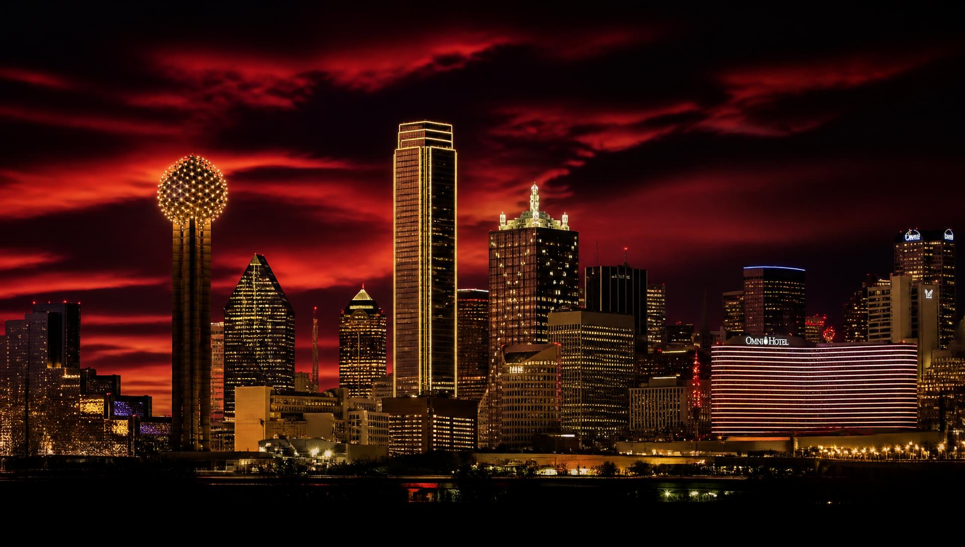Downtown Dallas skyline at night under a deep red sky